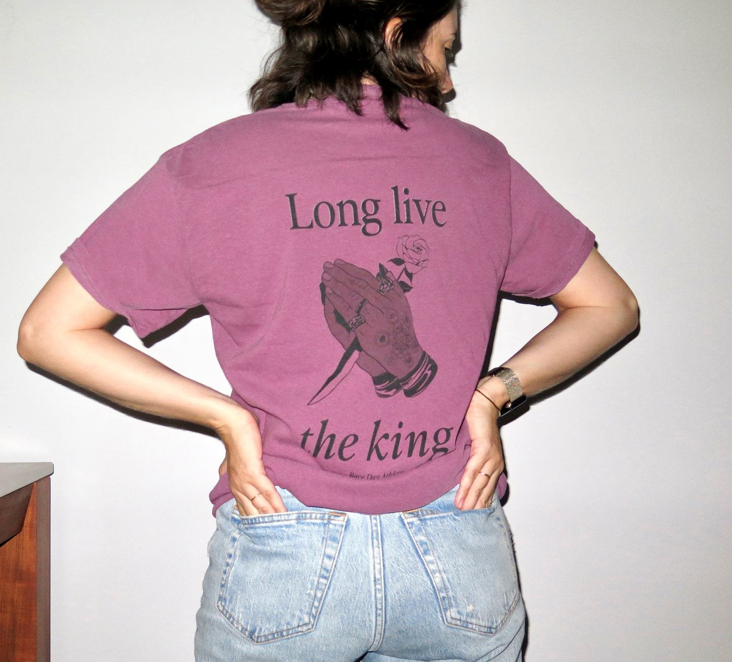 Lewish Hamilton Formula 1 driver berry purple comfort colors t-shirt with the words "long live the king" on them and a drawing of Lewis Hamilton's hands in a tattoo style illustration holding a blade and a rose