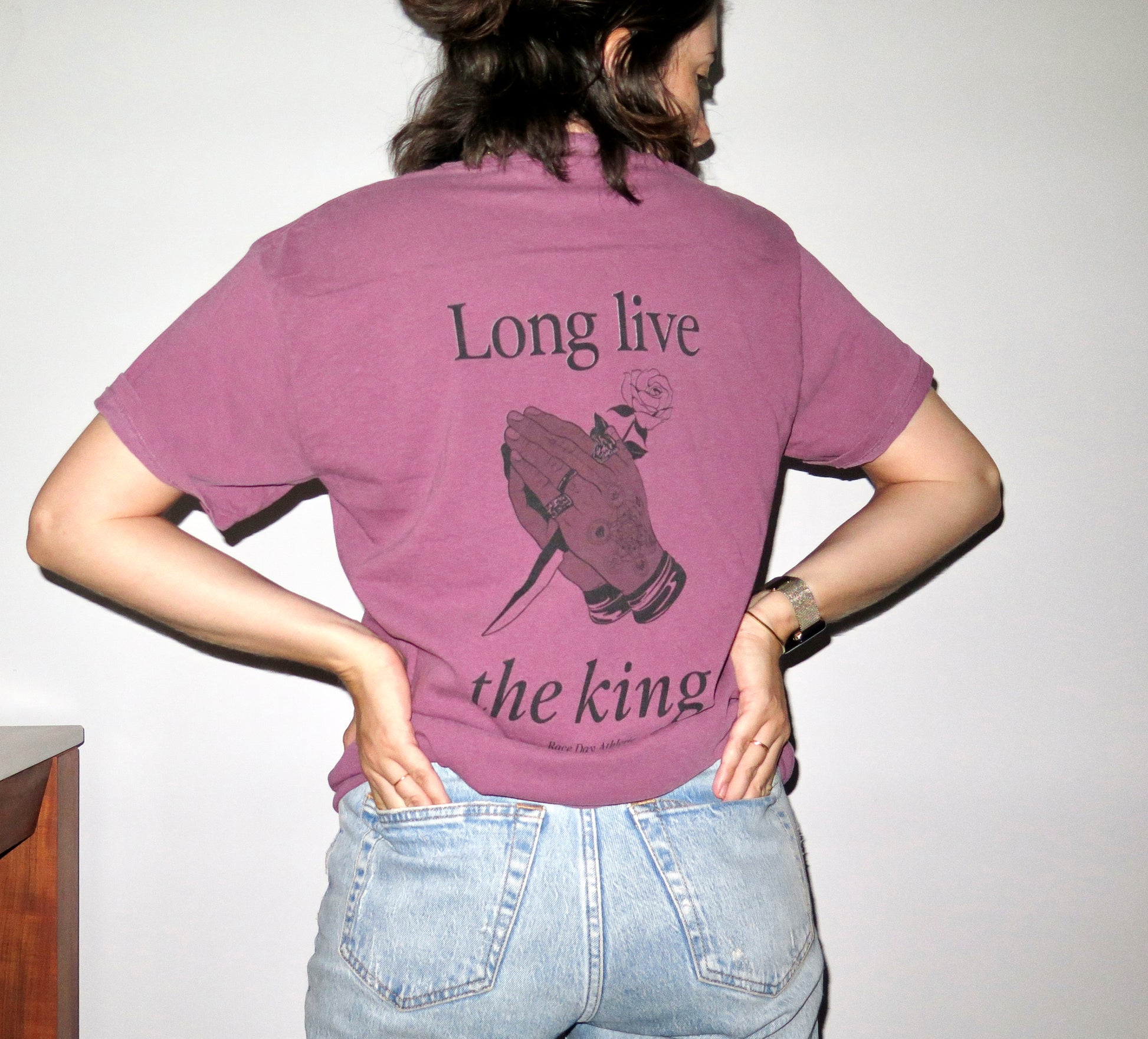 Lewish Hamilton Formula 1 driver berry purple comfort colors t-shirt with the words "long live the king" on them and a drawing of Lewis Hamilton's hands in a tattoo style illustration holding a blade and a rose